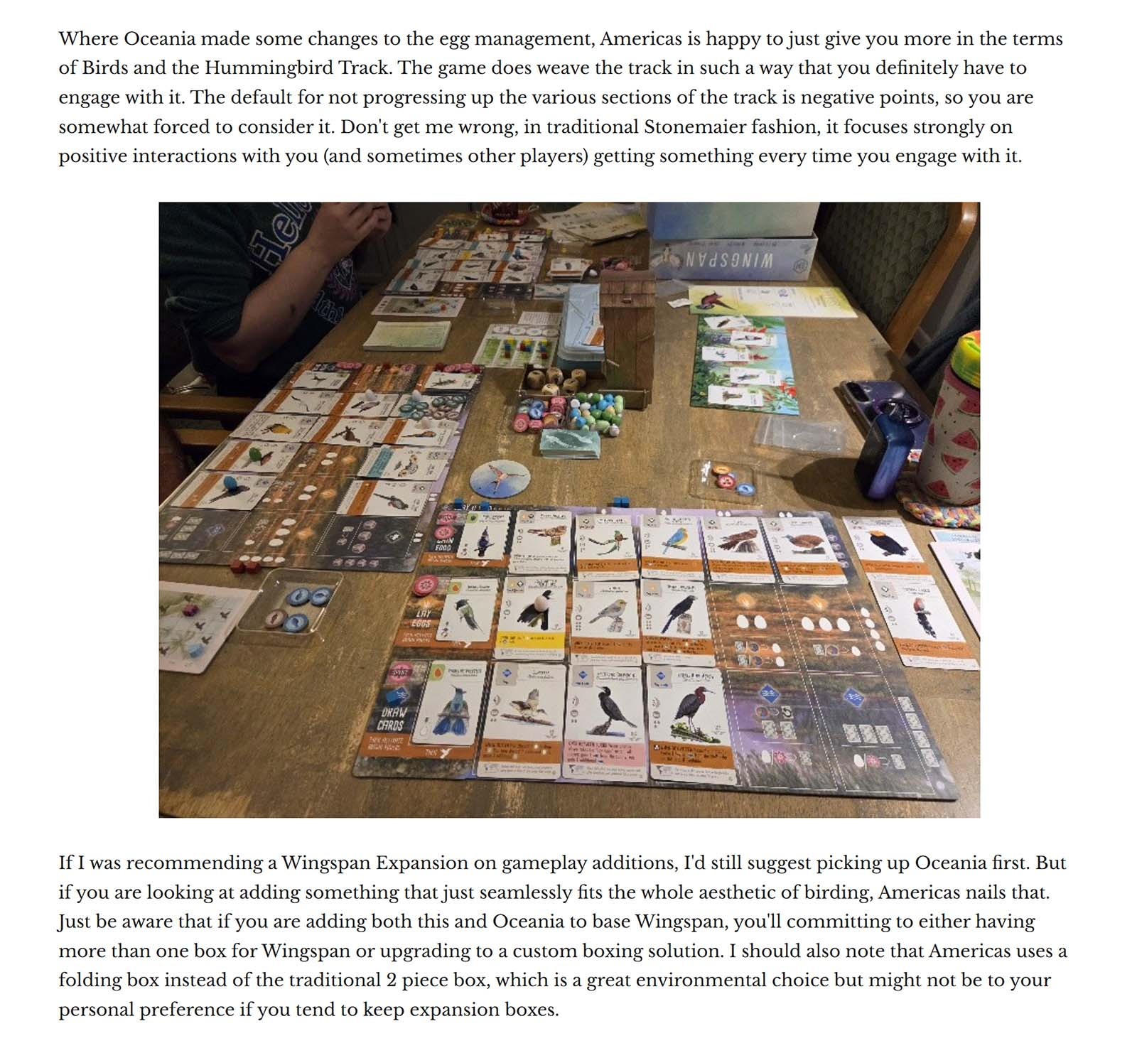 Wingspan board game setup on a table with bird cards, player boards, tokens, and game pieces